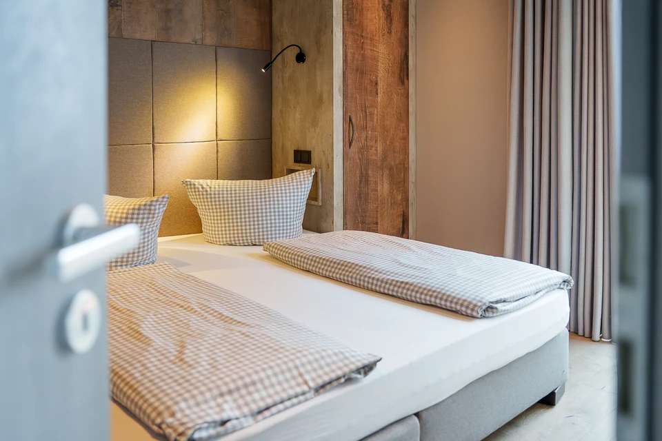 Prepared bedroom with timber and checked textiles at Strandberg