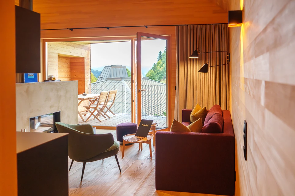 Timber and stone living space with an open balcony at Peterhof