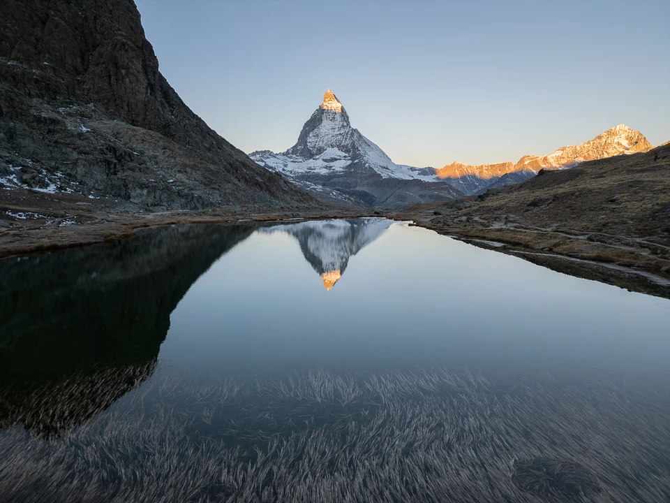 The Matterhorn in the first sunlight, clearly reflected in a mountain lake