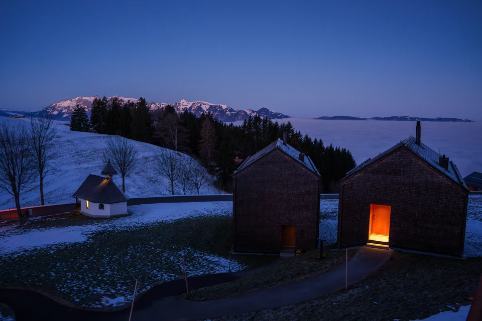 Winter chalets with a warmly lit open door at Peterhof